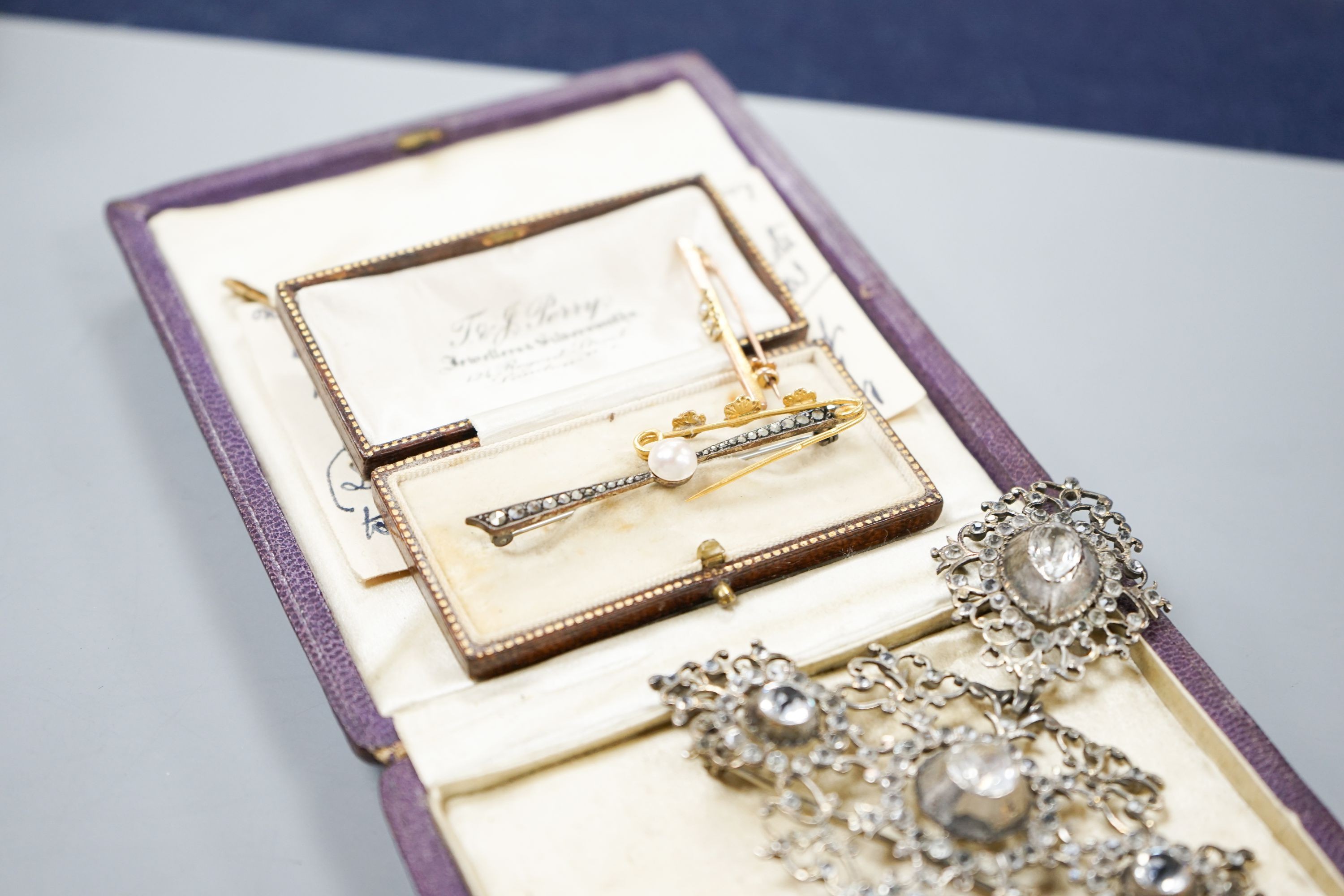 A white metal and paste set drop pendant, 10.7cm, a modern silver gilt bangle, a 9ct gold bar brooch, two other brooches and a marcasite set lorgnettes.